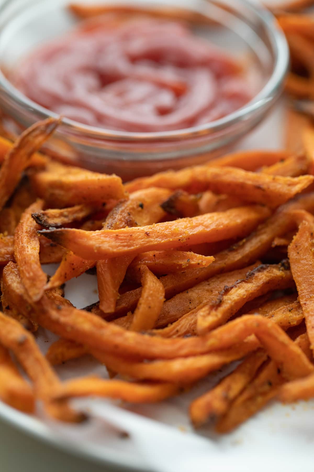 sweet potato fries on plate with ketchup