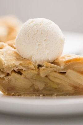 A slice of apple pie with vanilla ice cream on top