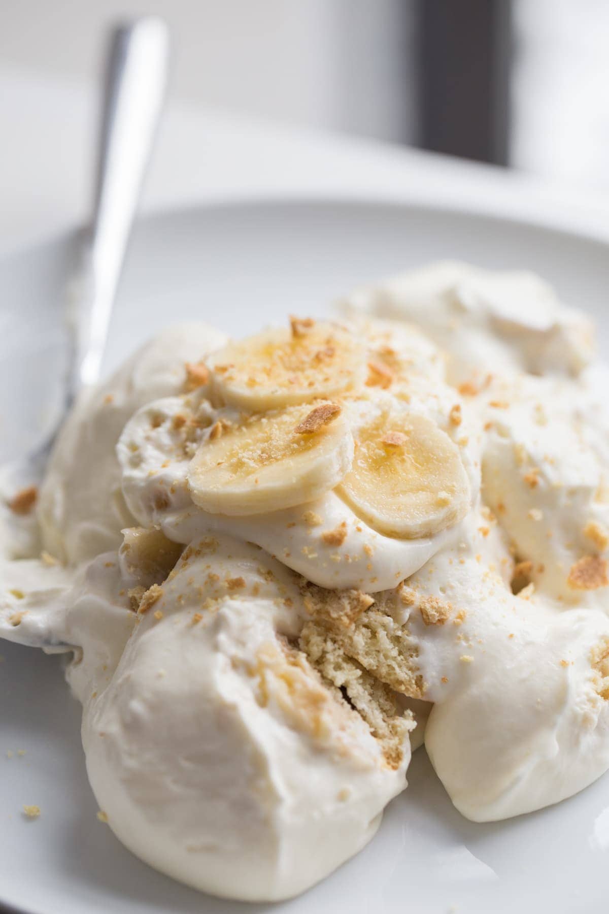 Banana pudding on white plate with spoon