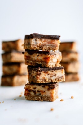 butterfinger nutter butter cheesecake bars cut stacked together